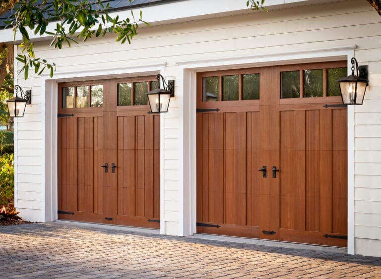Two faux wood garage doors on a house.