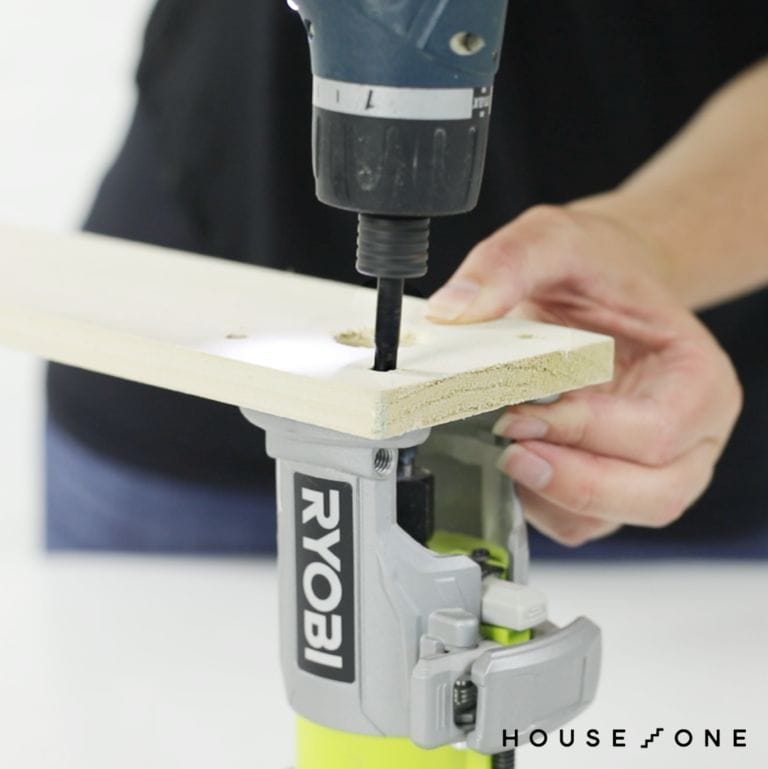 Attaching the board in the router to create the DIY circle jig.