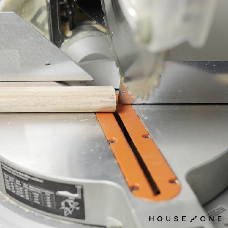 A miter saw is used to cut the legs of a stool.