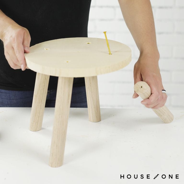 Legs are attached to a stool seat cut by a DIY circular jig.