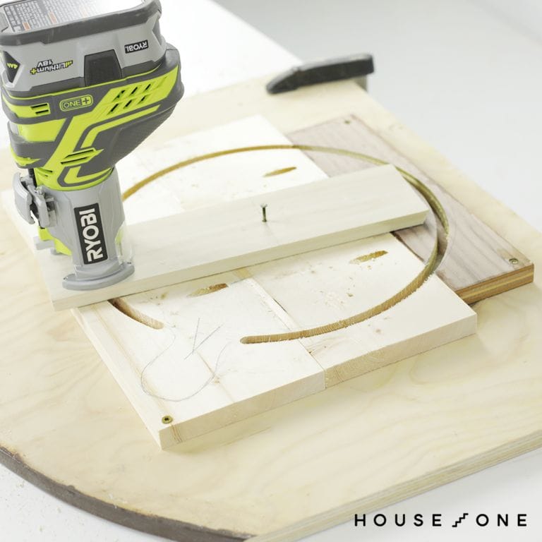 A person cut a semi circle using a DIY circle jig leaving space for a handle.