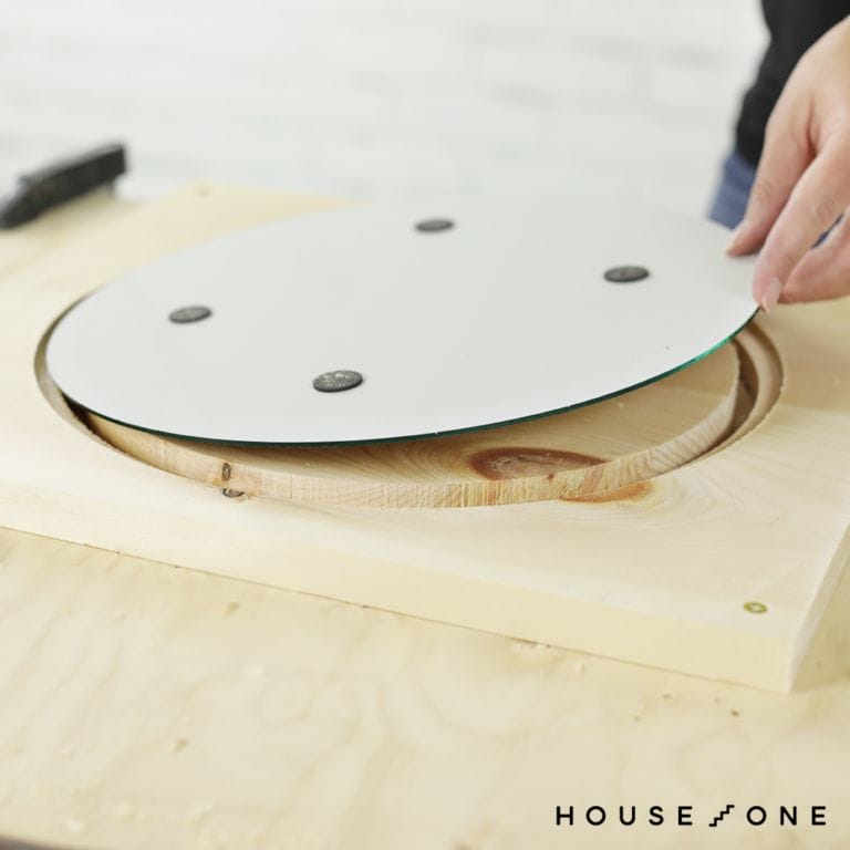 A mirror is laid in the grooves made by DIY circular saw.