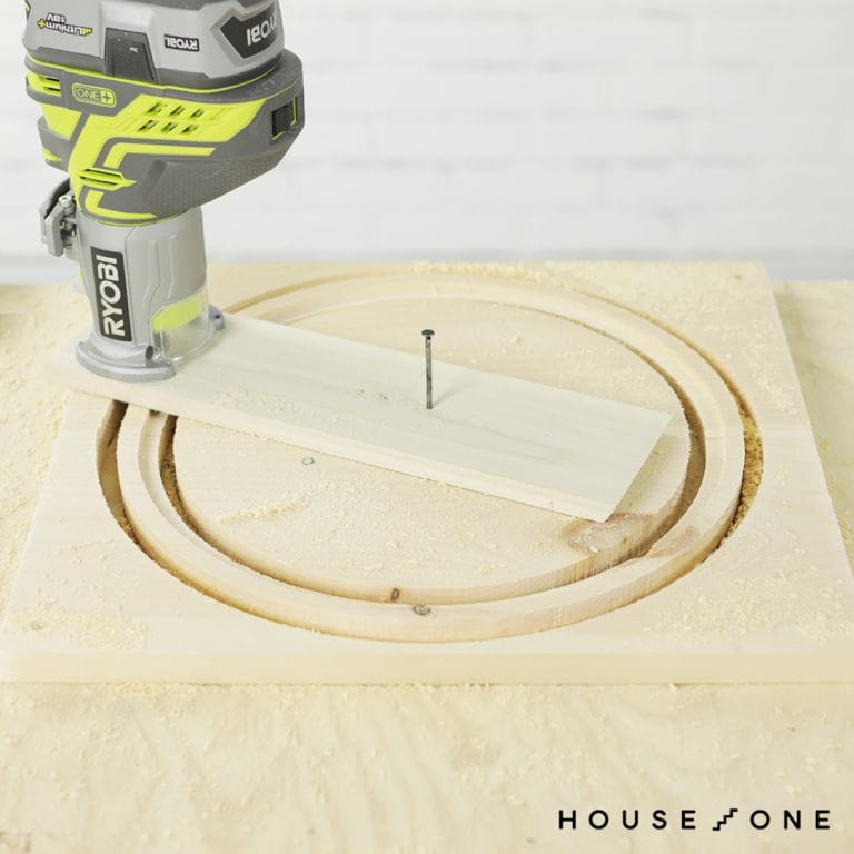 A DIY circle jig is used to cut the outer edge of a circle frame.