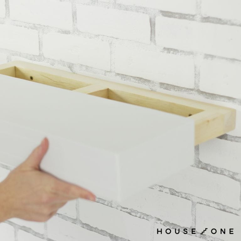 The floating shelf box slides onto the cleat.