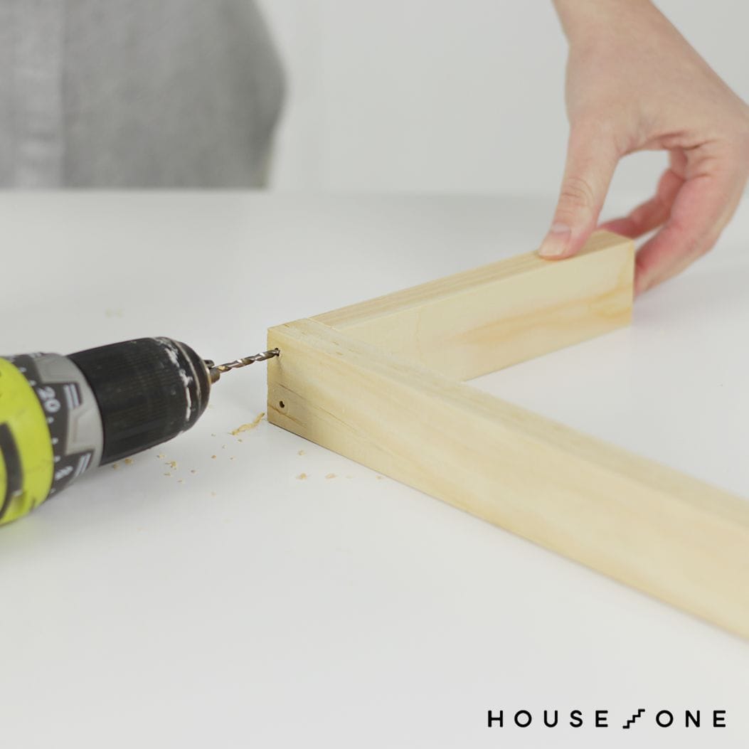 Holes are drilled in the floating shelf spacers.