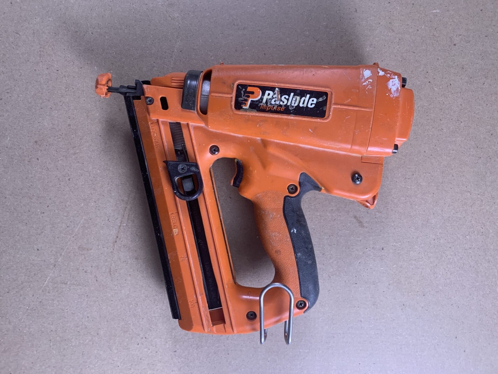 An orange Paslode 16-gauge finish nailer.