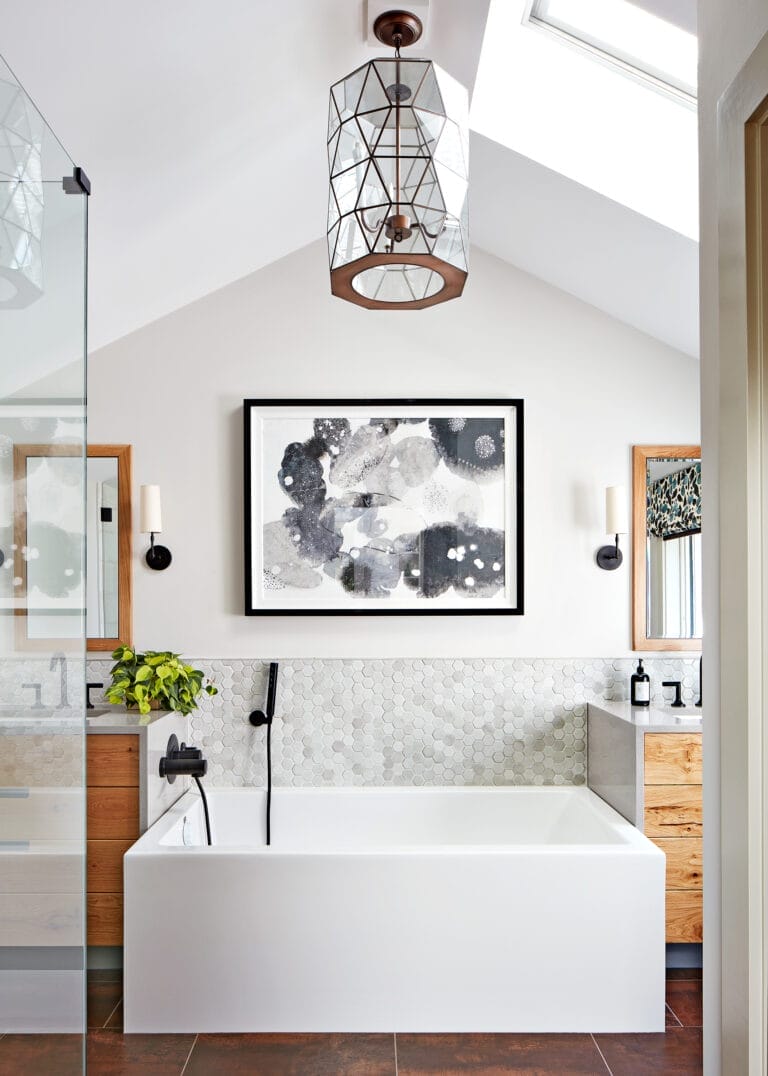 A small bathroom with a framed painting ang glass hanging light fixture.