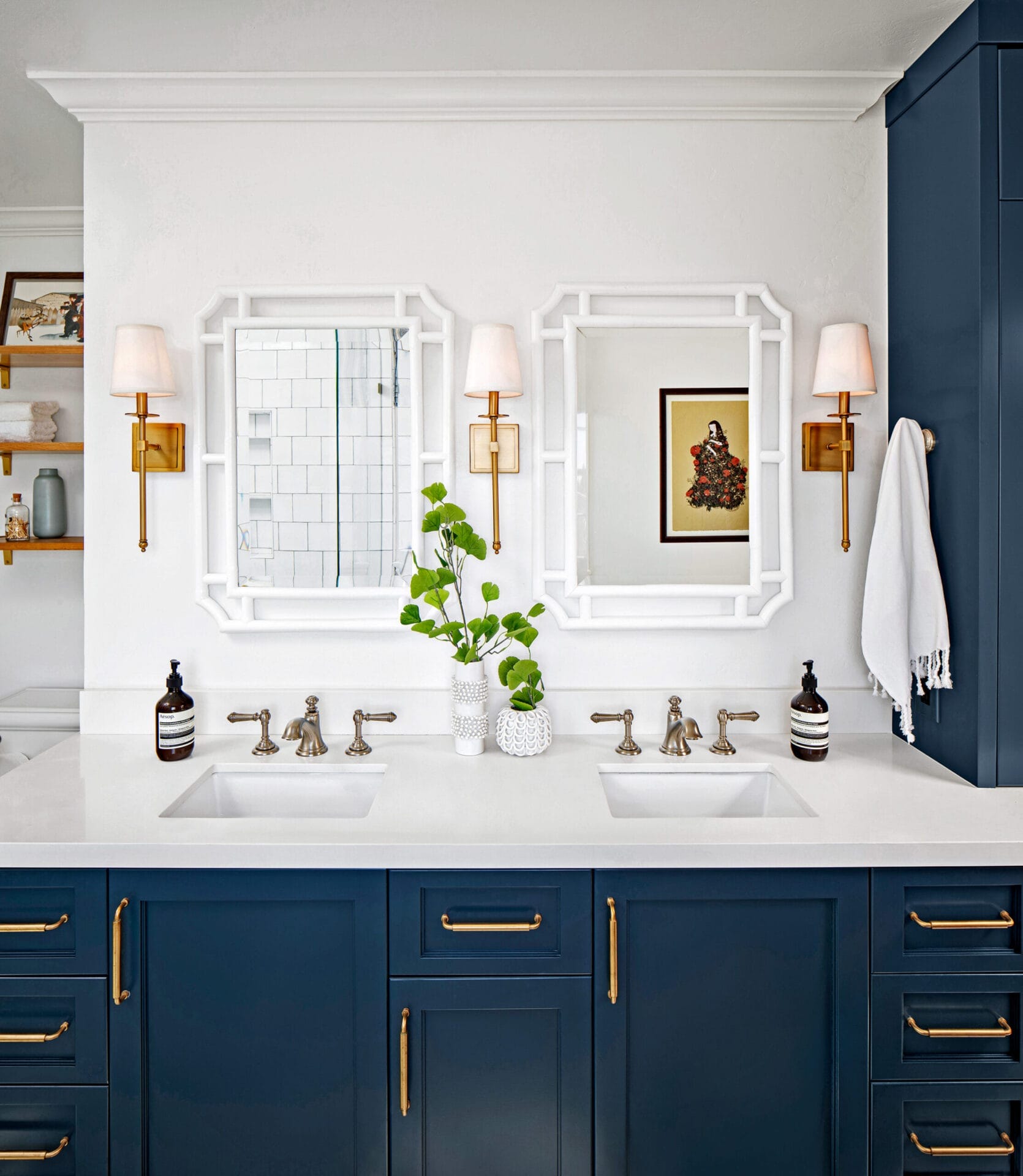 A small bathroom with two mirrors and sinks.