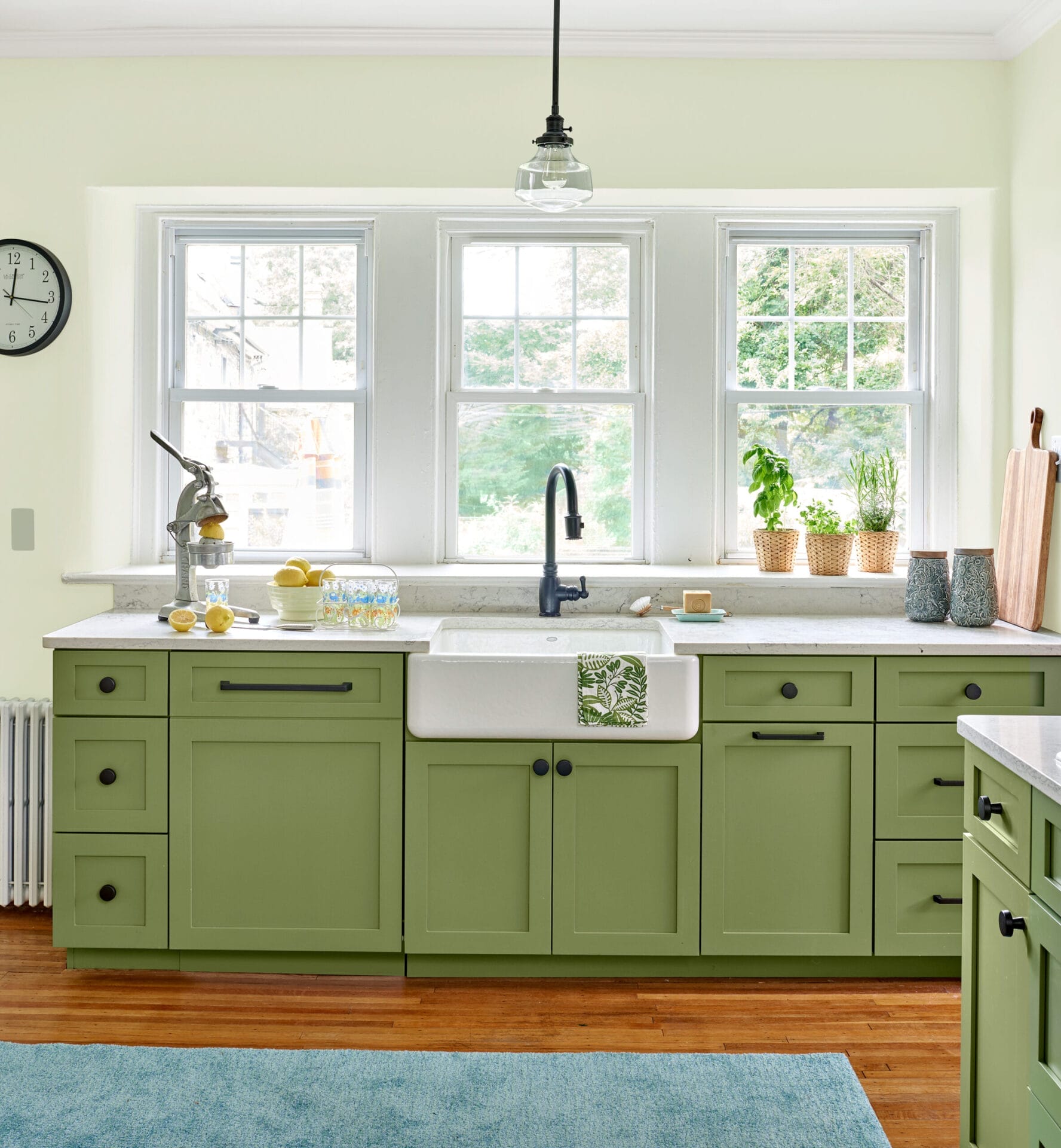 Kitchen sink positioned under existing windows for natural light and views.
