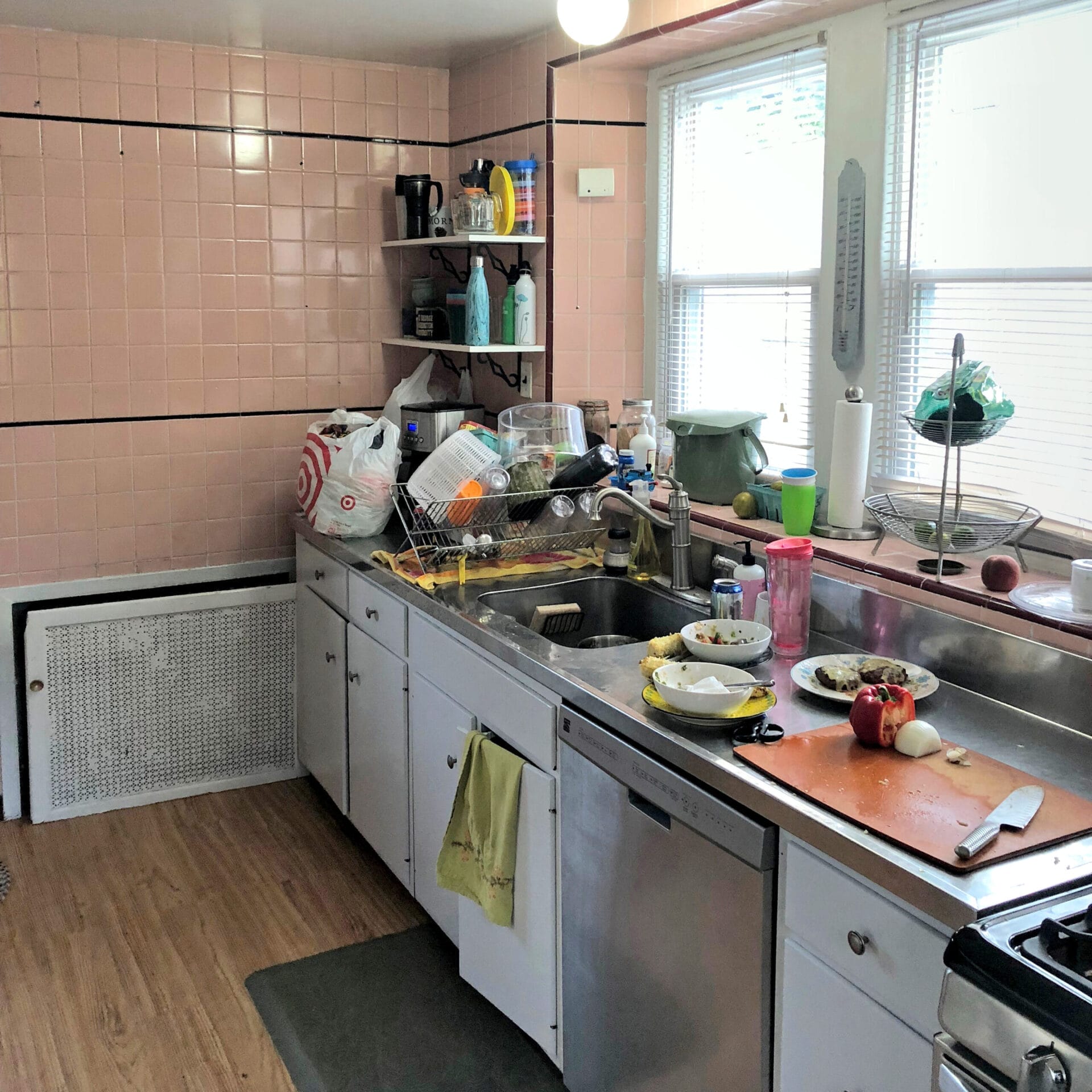 Kitchen before renovation showing cramped space in uninsulated extension area.