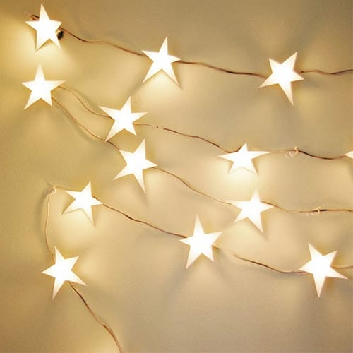 Lights in the shape of stars hanging from a string.