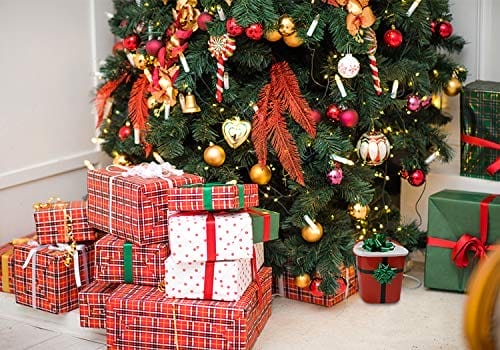 A Christmas tree with present under it.
