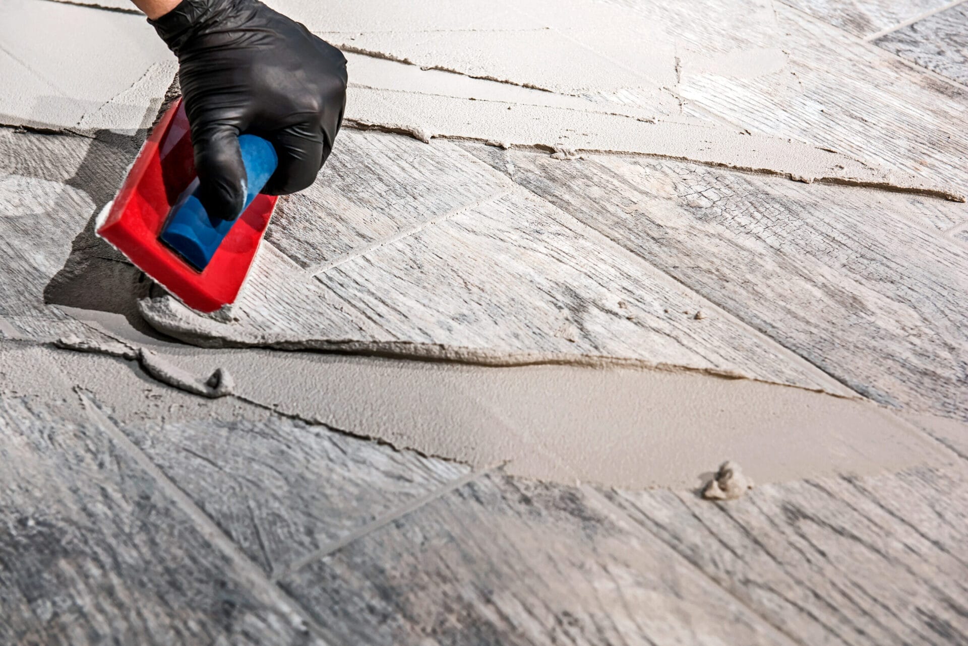 Grout being spread for tile installation.
