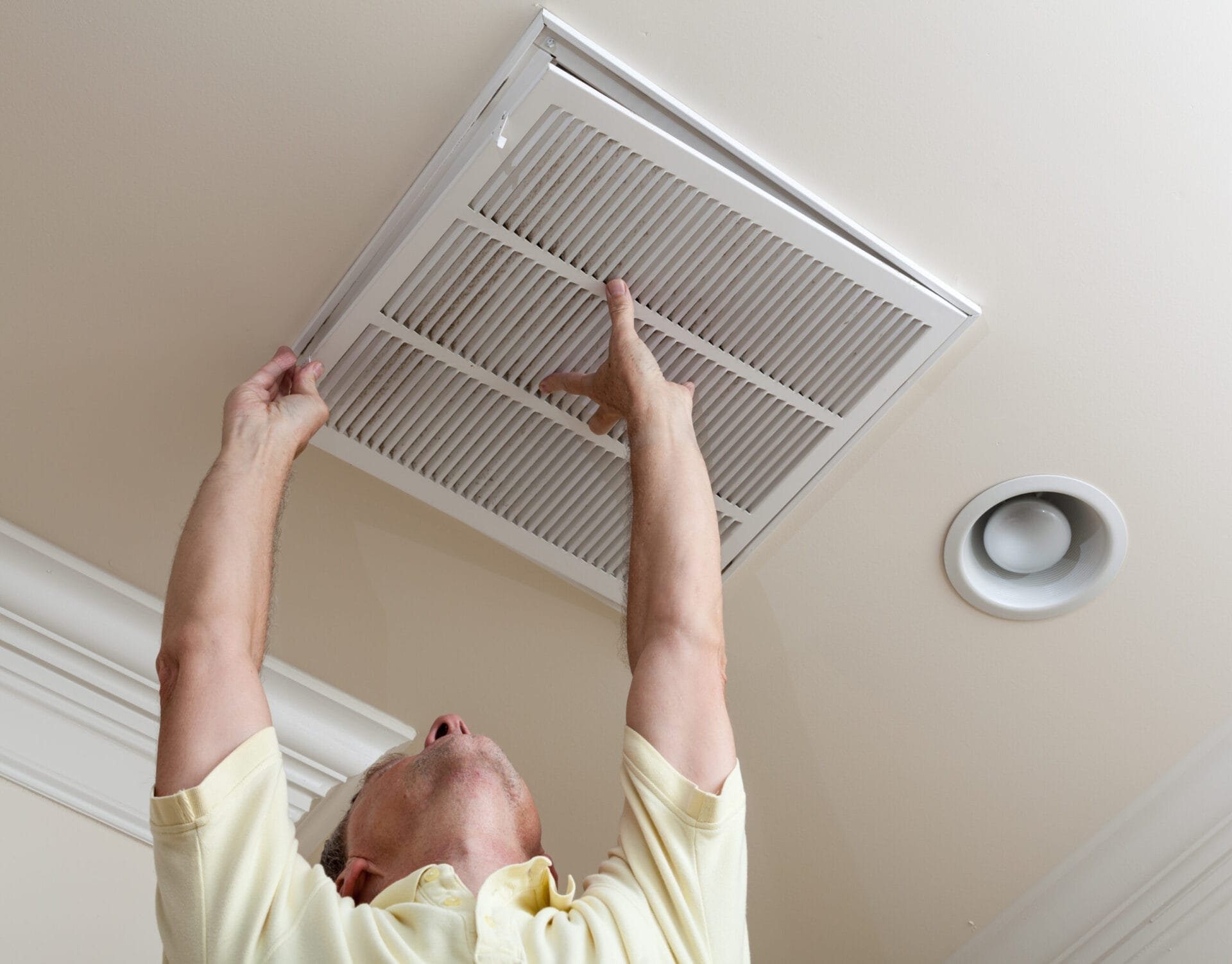 image of a homeowner changing an air filter