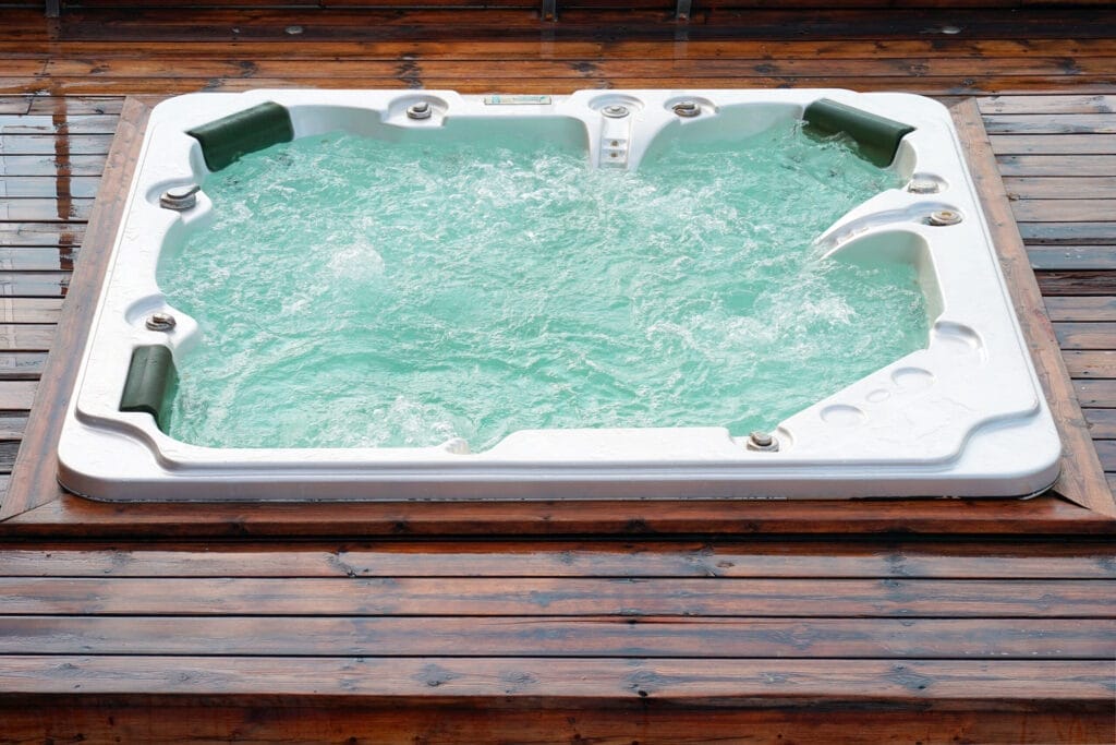 A clean hot tub installed on a wooden deck.