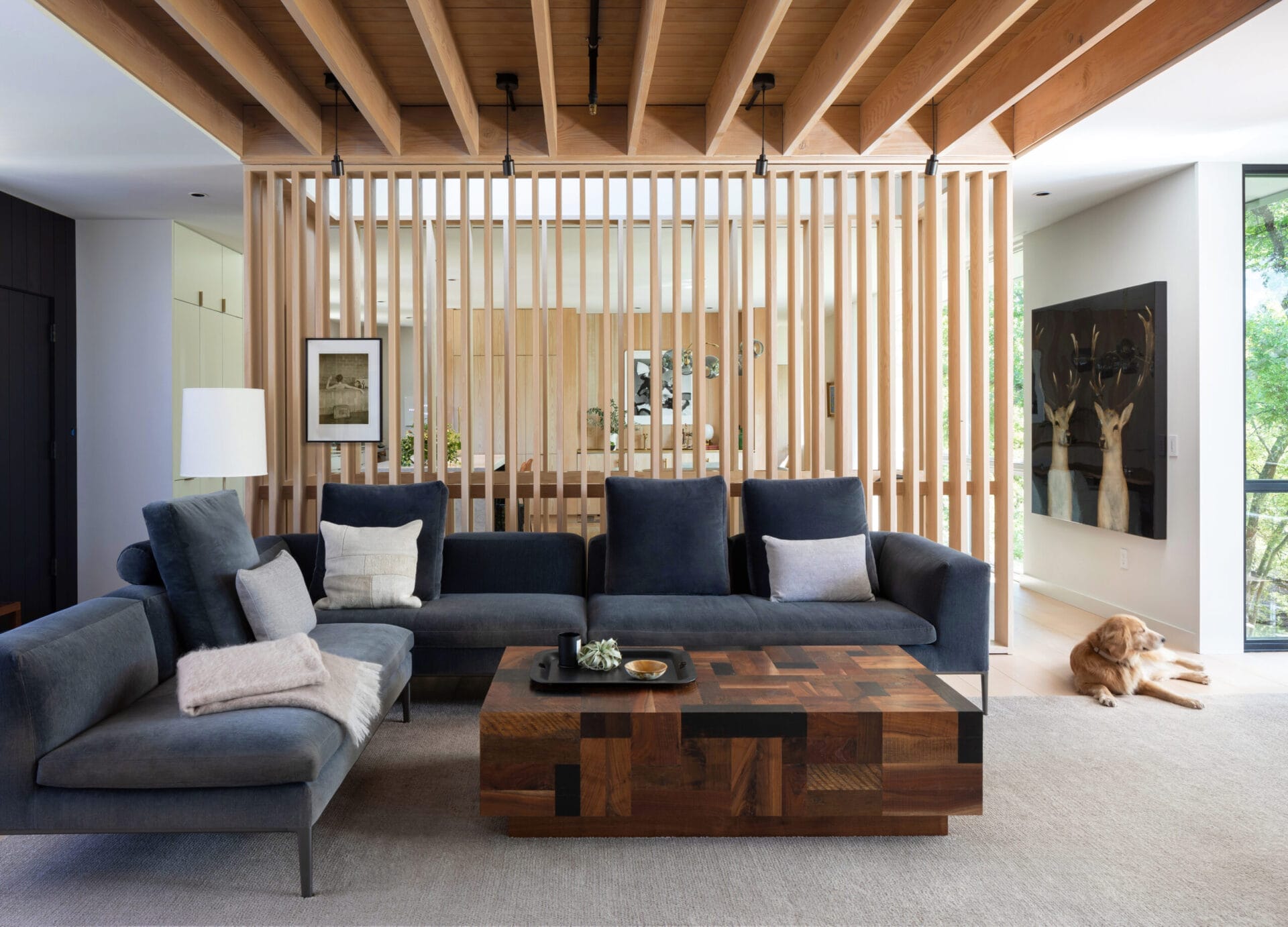 A room with a wooden slat room divider.