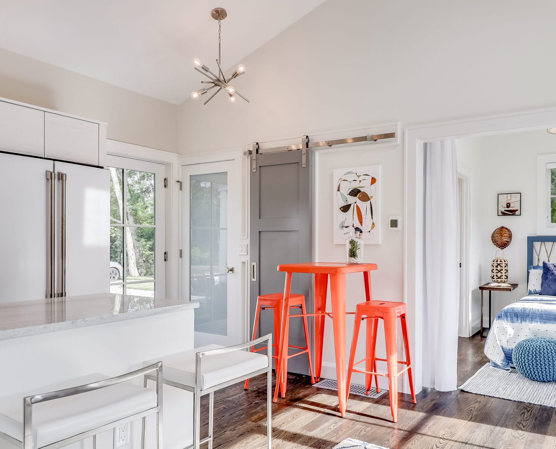 Chandelier lighting over a kitchen.