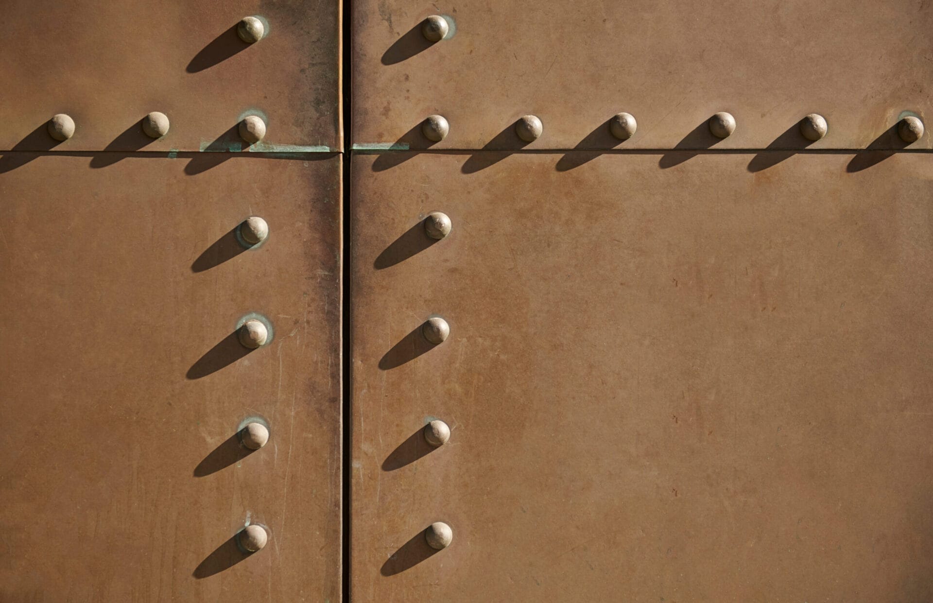 A set of rivets in a wall to be removed.