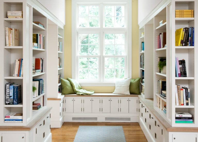 Built-in bookshelves with a reading nook by a window.