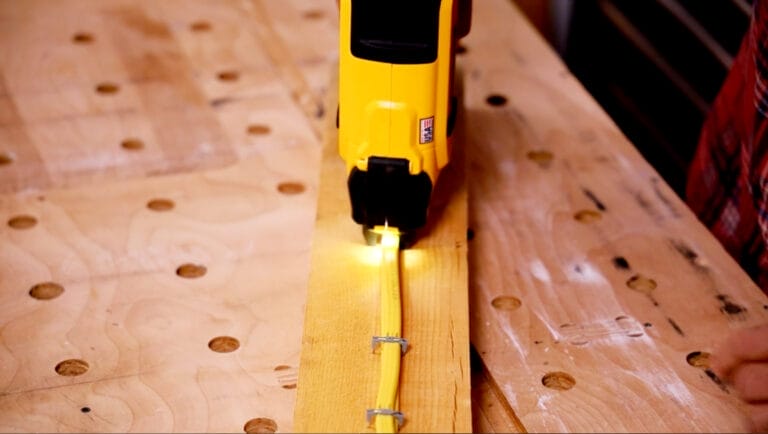 A DeWalt Cordless Cable Stapler being used to apply staples to a cable.