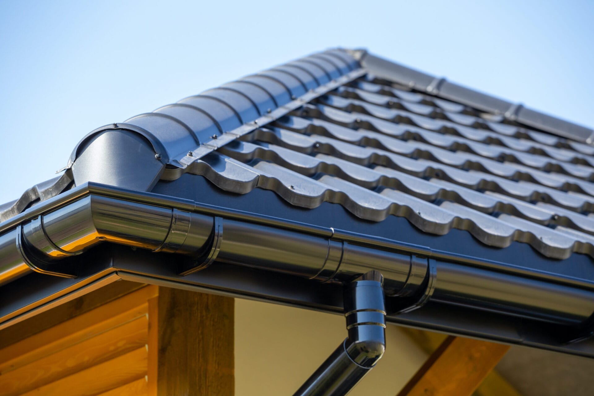 Black half-round gutters on a house.