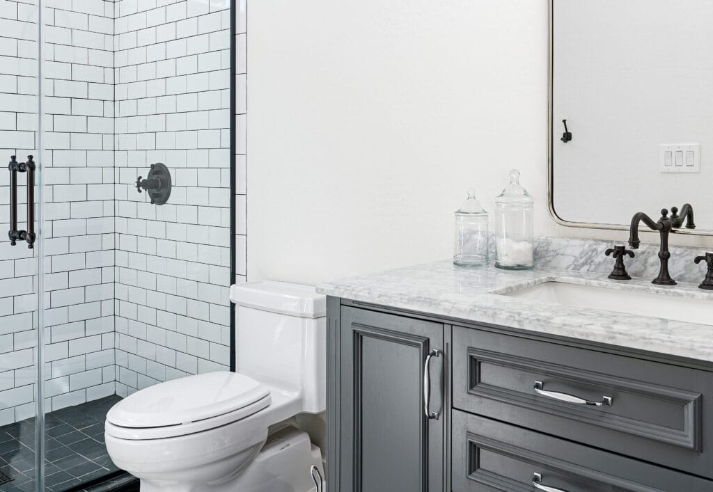 A Toilet sitting in a bathroom beside a sink and shower.