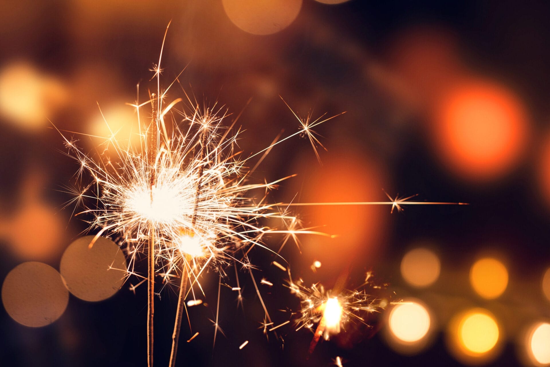 Image of sparklers being used to celebrate an occasion. It is important to learn home fireworks safety when using sparklers and fireworks.
