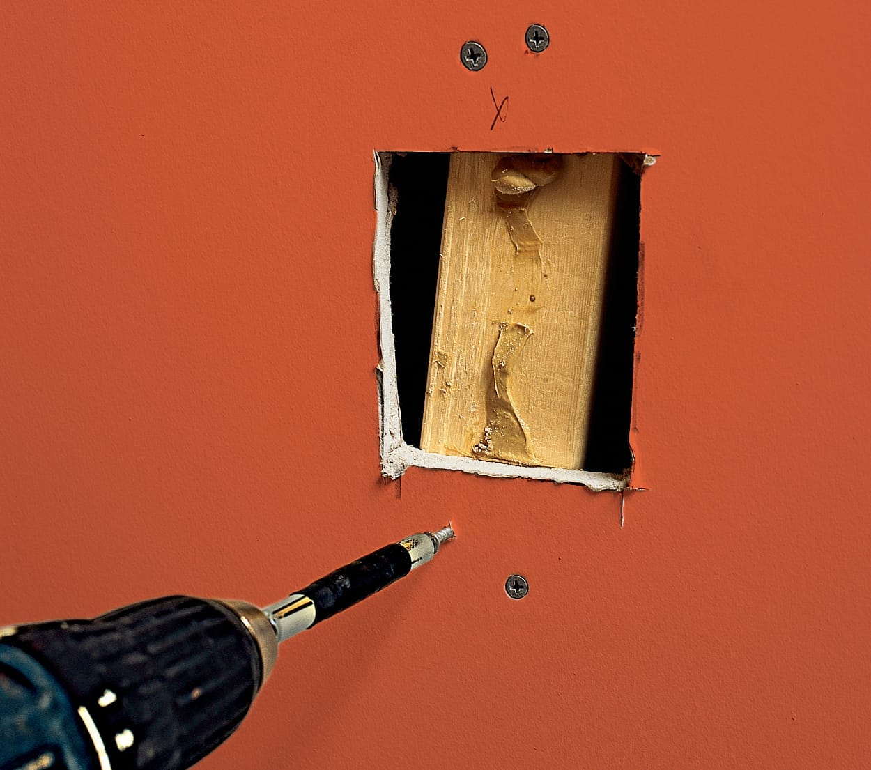 Strapping is added to a drywall hole.