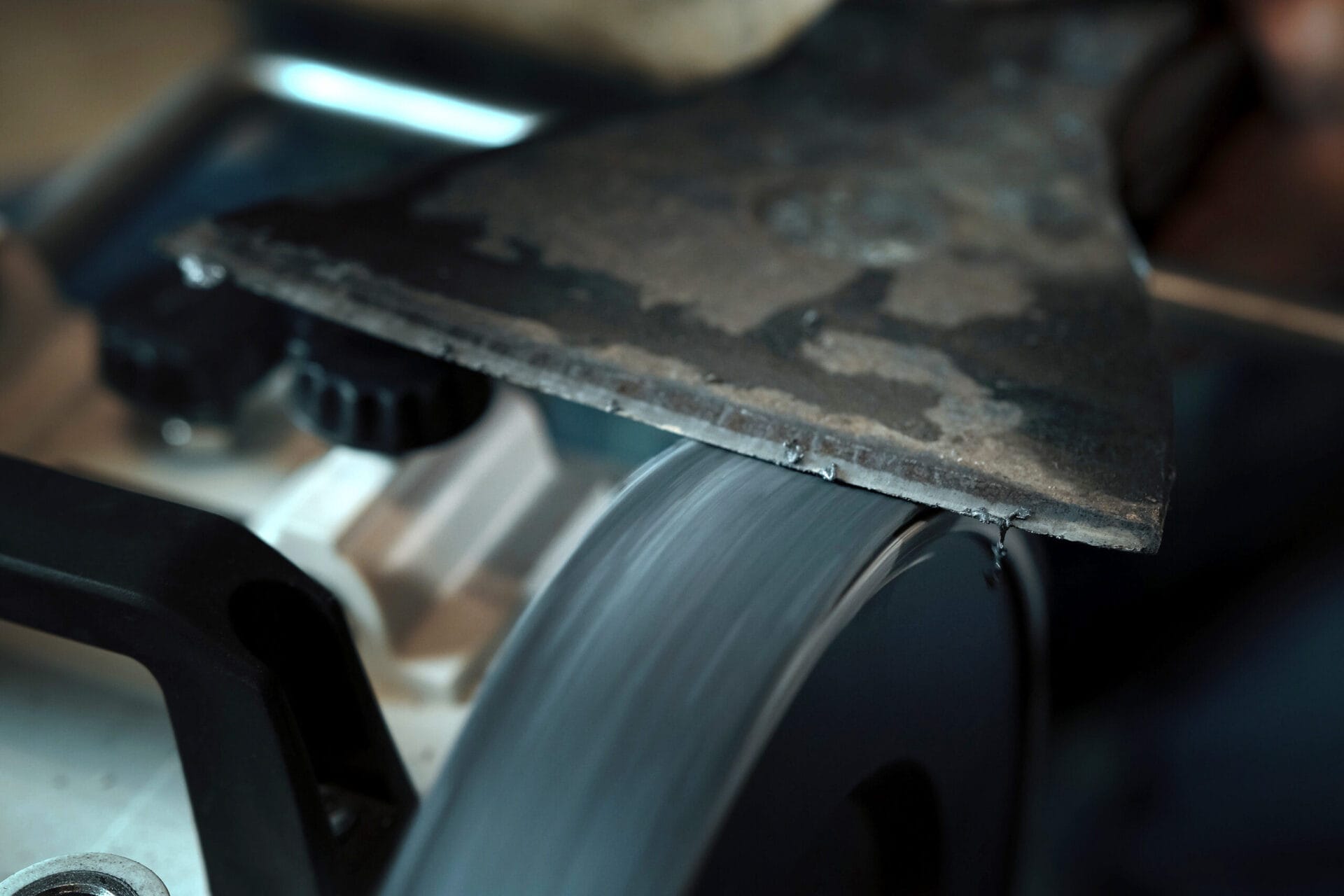 using a bench grinder to sharpen an ax
