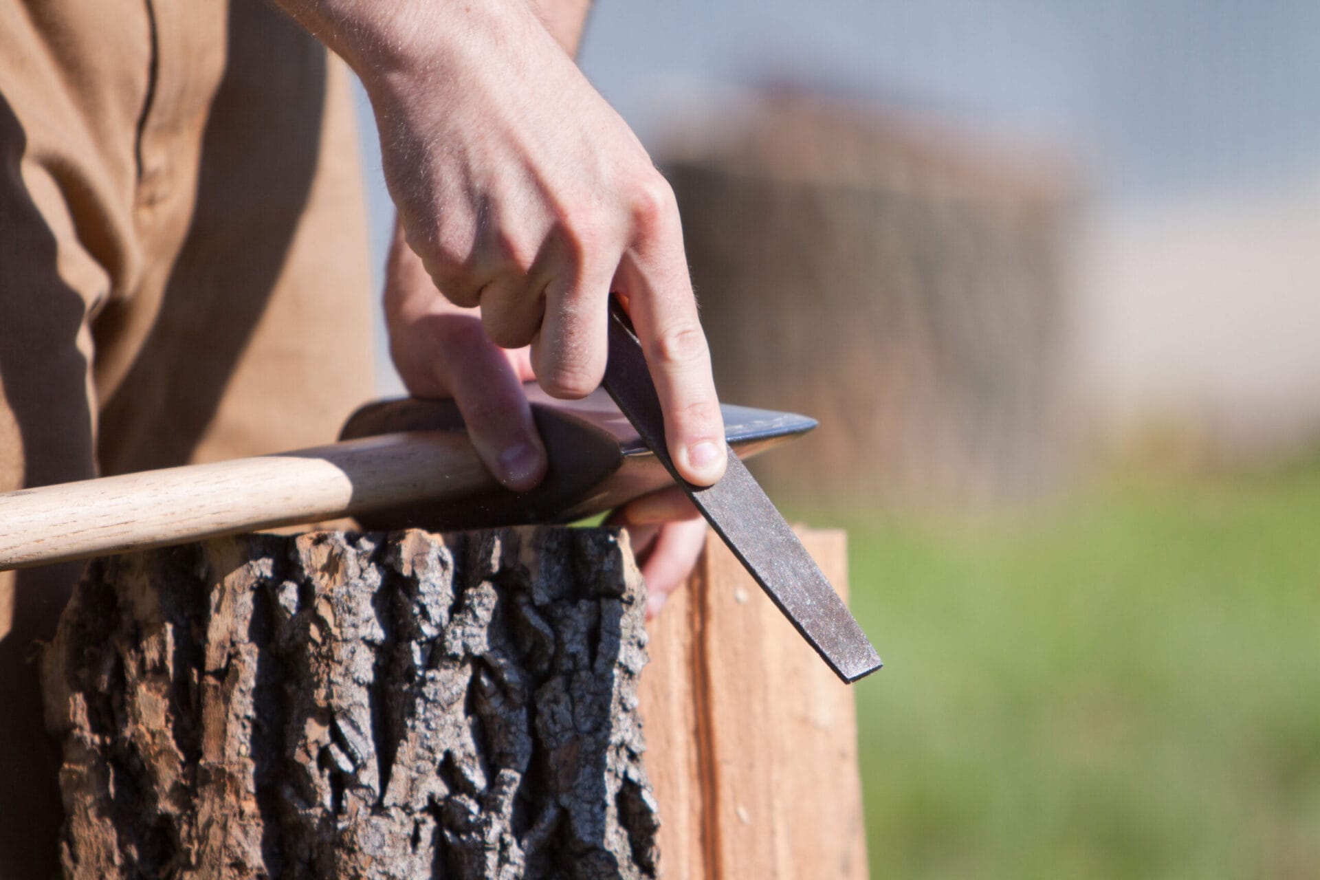 using a file to sharpen an ax