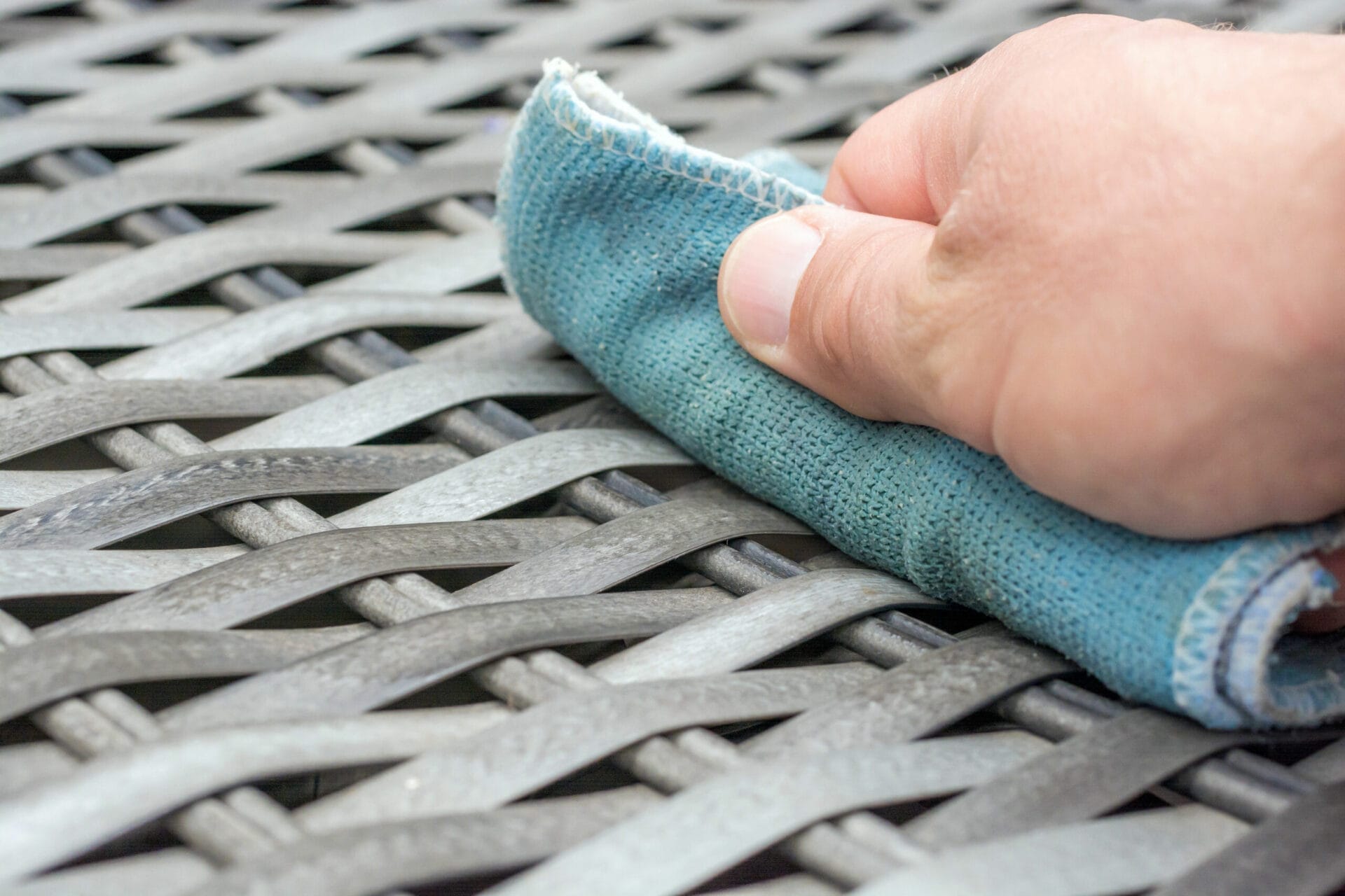 using a cloth to clean and maintain outdoor furniture