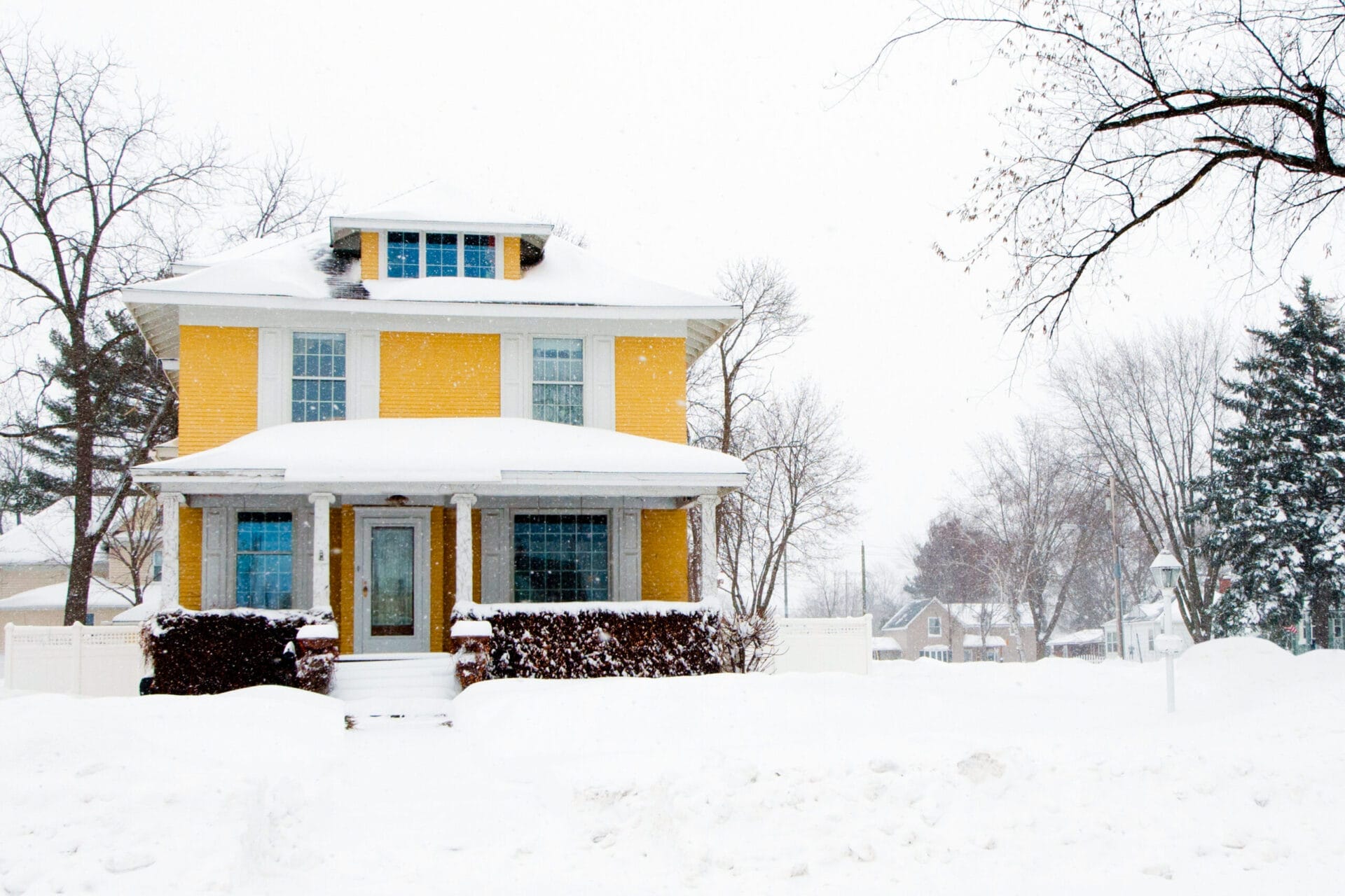 a home that is covered in snow during the winter