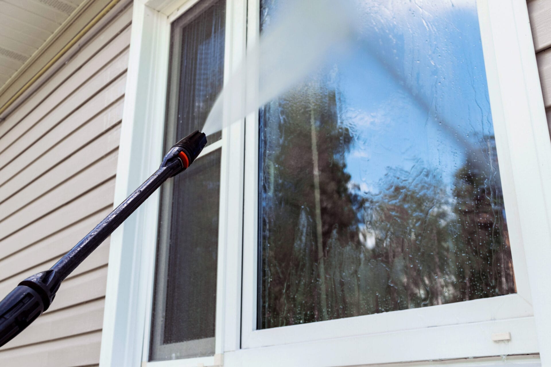 A window being pressure washed.