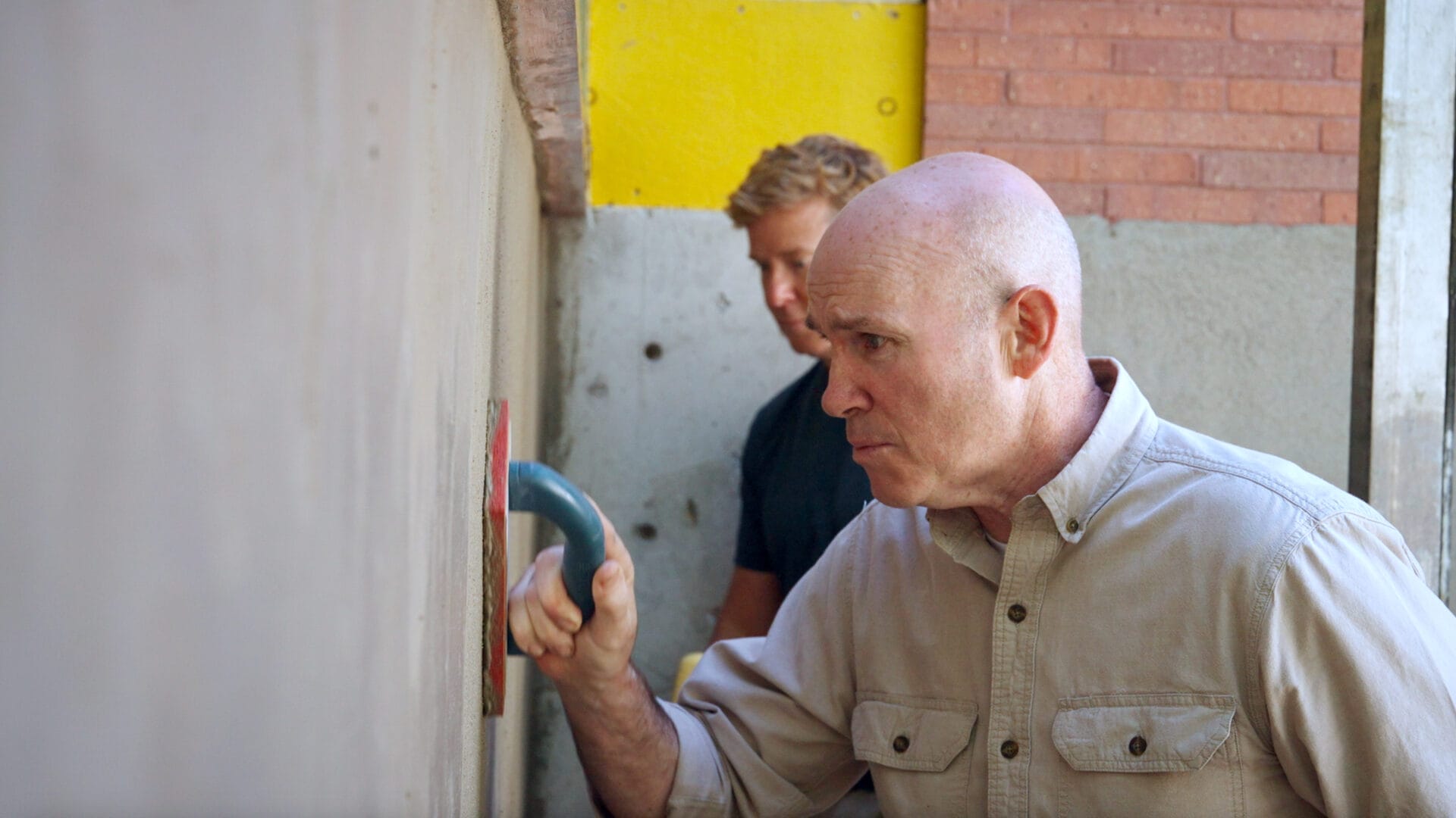 Mason Mark McCullough works on a home's concrete foundation.