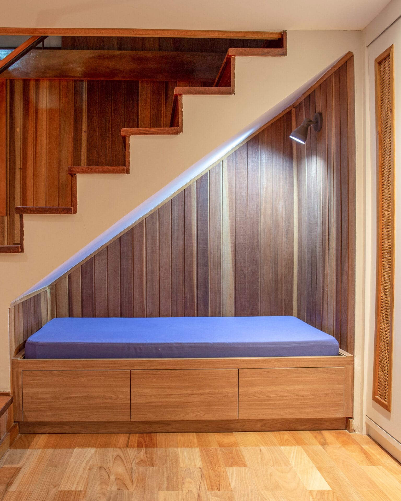 A reading nook under a staircase