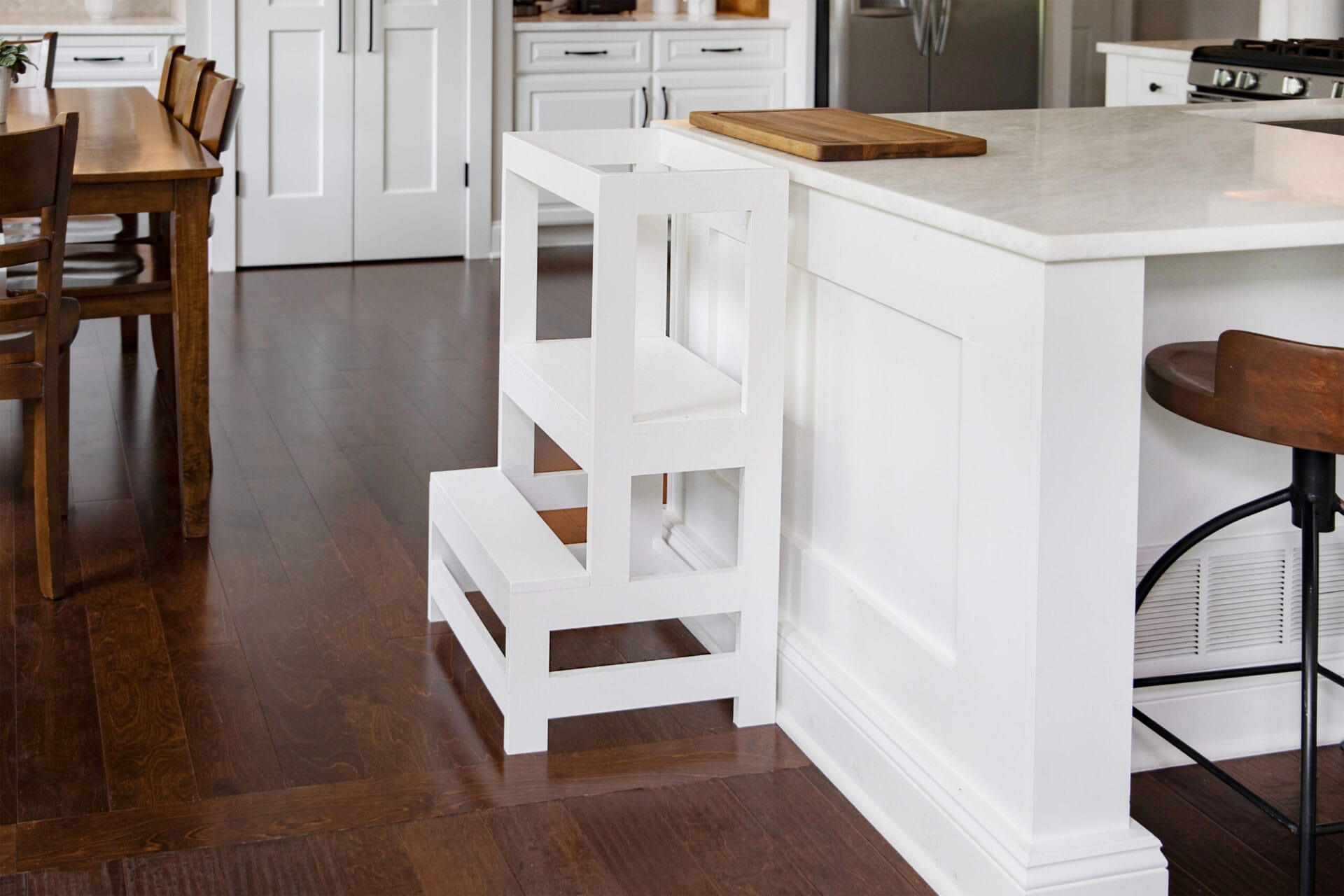 A toddler step stool against a kitchen island