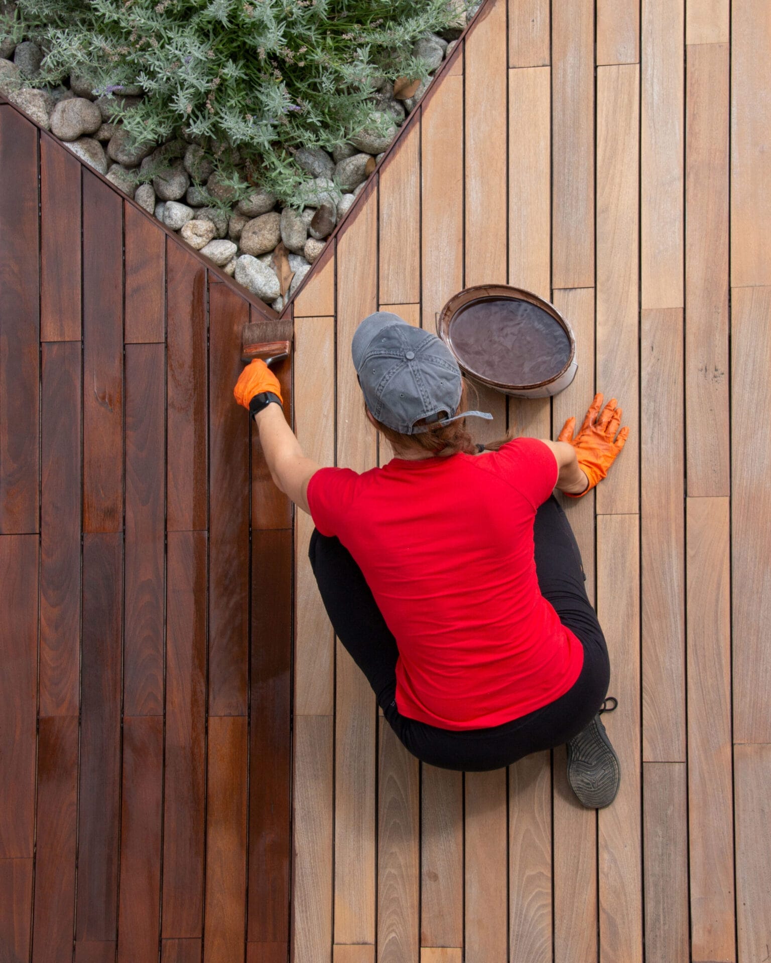 woman staining a deck