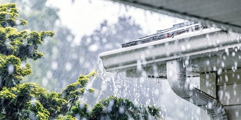 Water flowing out of a gutter system