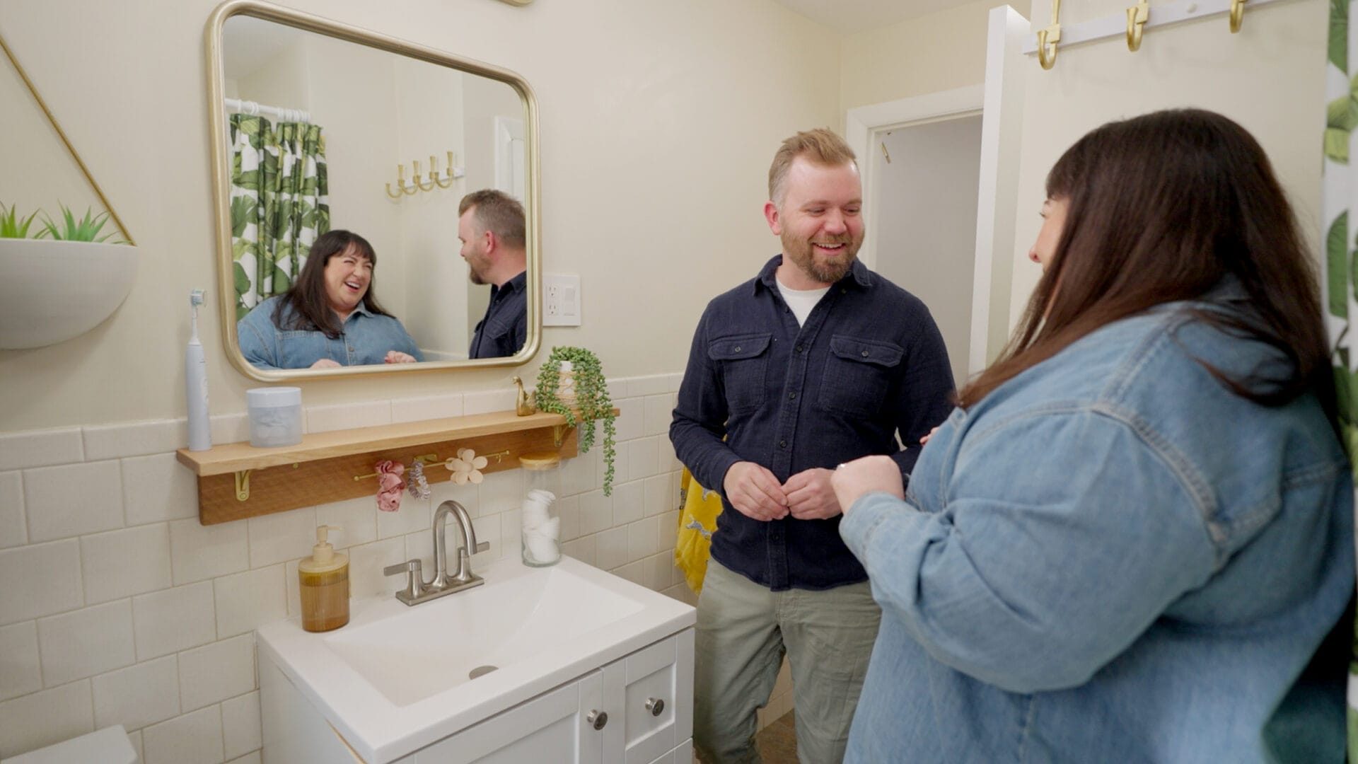S24 E24: Nathan Gilbert upgrades a bathroom by removing vintage wall-mounted ceramic toothbrush and soap holders and replacing them with a more functional, modern wood shelf.